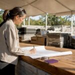 Project manager reviewing kitchen blueprints onsite