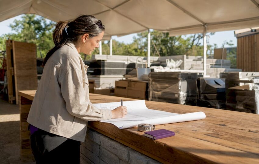 Project manager reviewing kitchen blueprints onsite