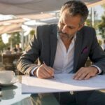 Contractor reviewing blueprints in meeting