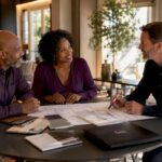 Couple consulting a sunroom contractor in home