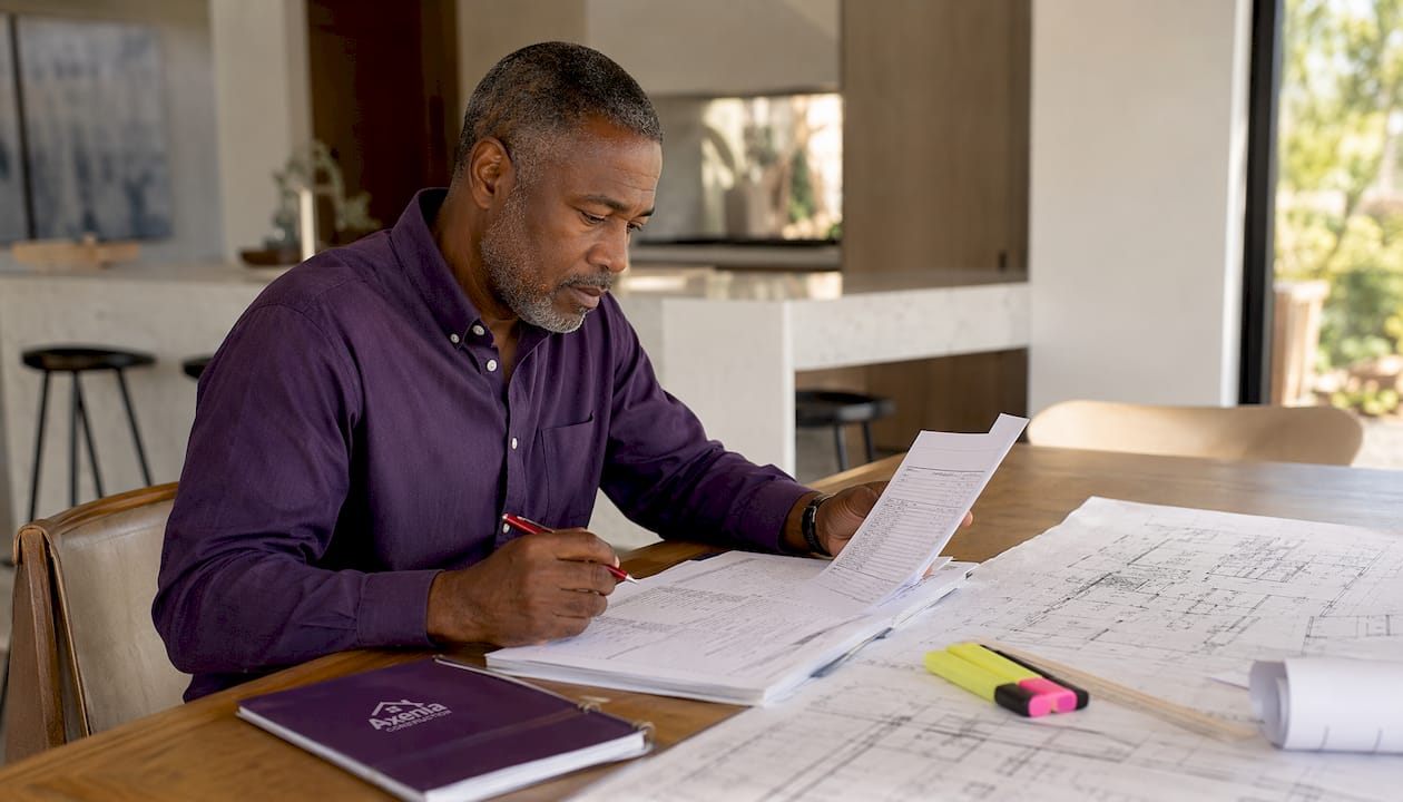 Man reviewing contractor bid in home office