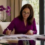 Homeowner reviewing renovation loan documents at kitchen table