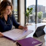 Homeowner reviewing construction plans at kitchen table