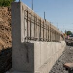 Commercial construction site with cantilever retaining wall