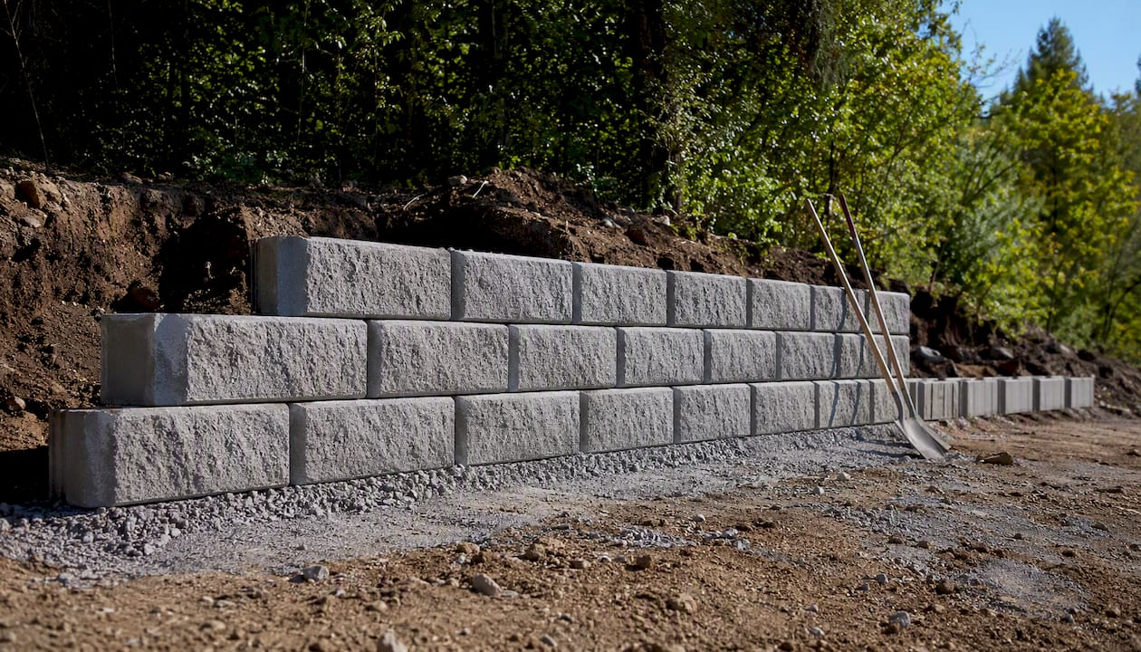 Segmental concrete blocks assembling a retaining wall