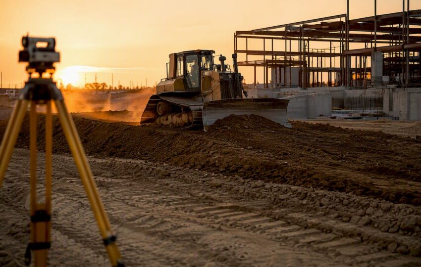 Bulldozer grading soil on commercial site