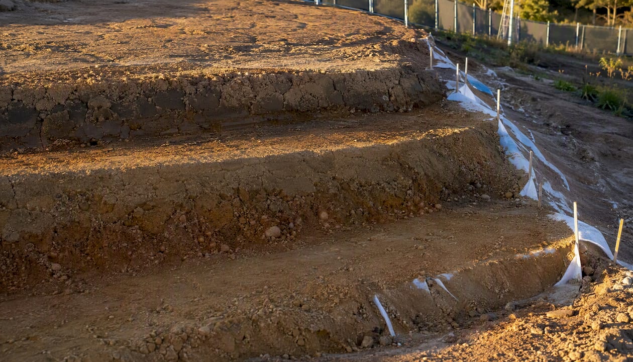 Horizontal bench step in graded soil slope