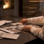 Hands using calculator with home renovation paperwork