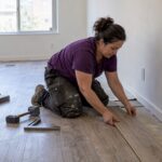 Installer fitting flooring in a vacant rental apartment