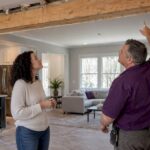 Homeowner and contractor inspect an open-plan remodel