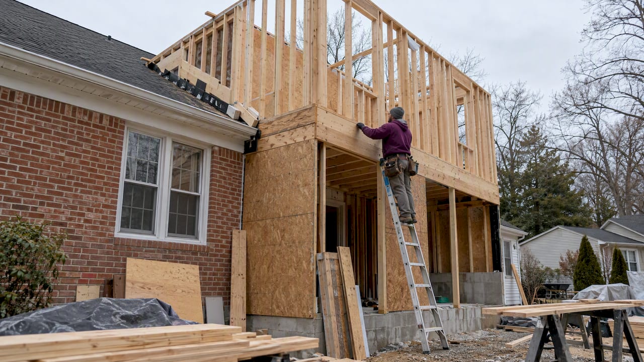 Two-story addition framing beside a Maryland home