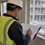Superintendent compares schedule with active construction site