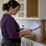 Contractor reviewing permits in a remodeling kitchen