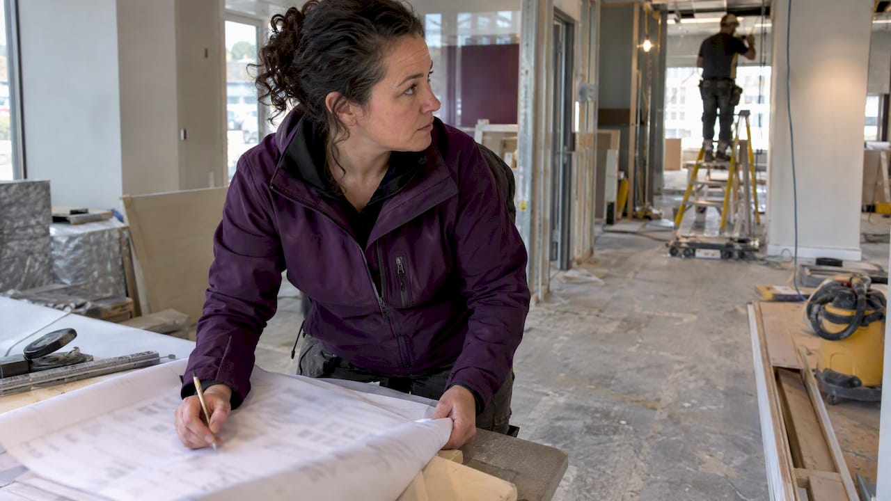 Project manager reviewing a construction budget on site
