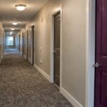 Renovated multifamily corridor with purple door