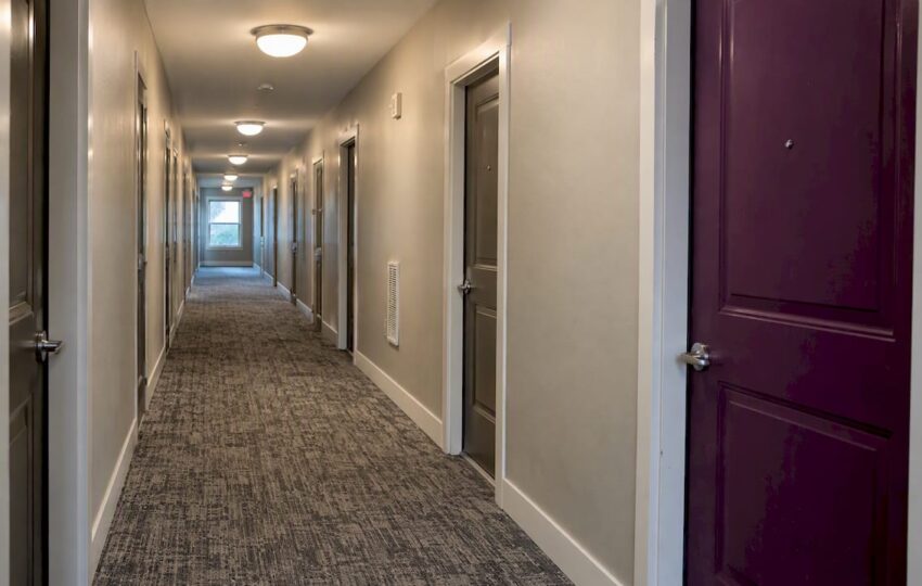 Renovated multifamily corridor with purple door