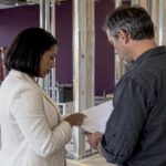 Tenant and contractor reviewing office build-out costs
